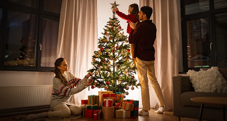 Familia decorando el arbol de navidad
